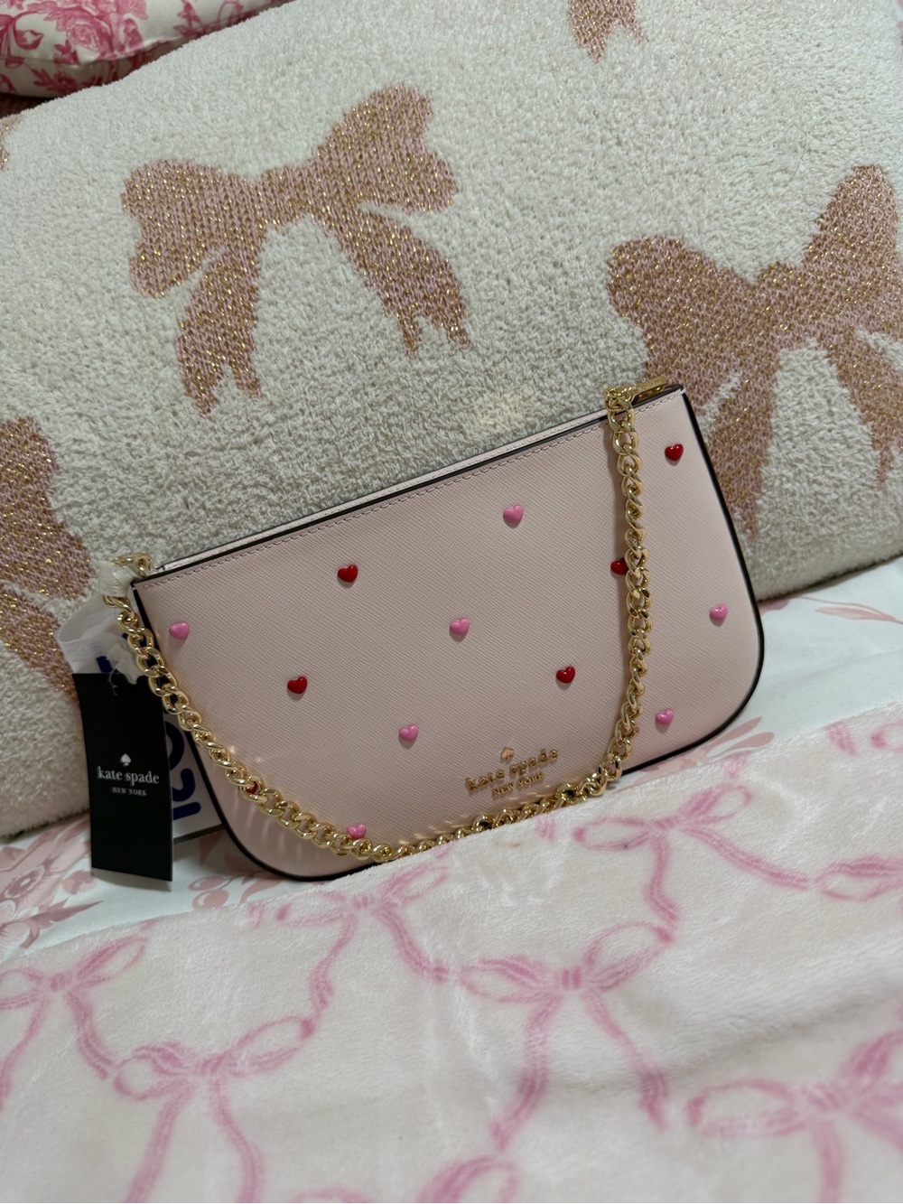 kate spade Pink Heart-Studded Chain wristlet.